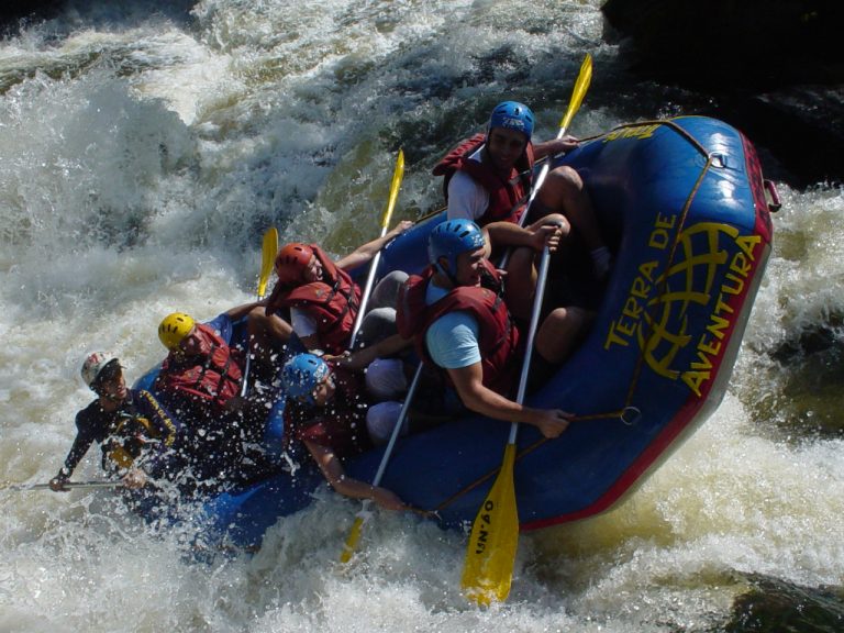 A professional rafting team navigating the Class IV rapids of the Bhote Koshi River in Nepal.