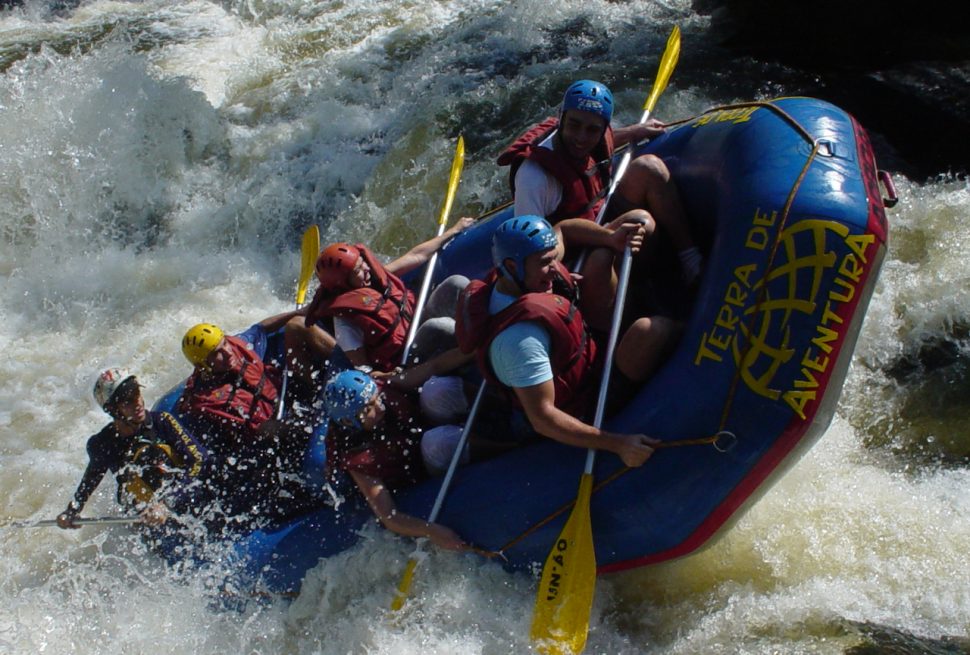 A professional rafting team navigating the Class IV rapids of the Bhote Koshi River in Nepal.