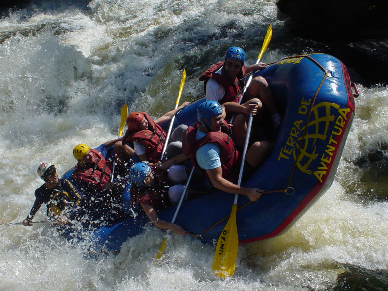 A professional rafting team navigating the Class IV rapids of the Bhote Koshi River in Nepal.